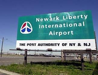 Newark Liberty International Airport: A bustling airport with planes on runways, terminals, and a control tower.