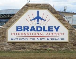 Bradley International Airport with airplanes on tarmac and control tower.